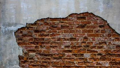 Texture of old red brick wall. Grunge background brick wall. Painted rough wall surface. Shabby building facade with damaged plaster. Abstract web banner. Copy space.