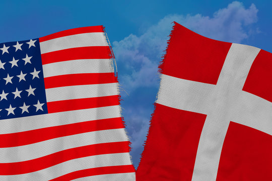 torn fabric with the image of American and Danish flags against a stormy sky, the concept of the deterioration of international relations