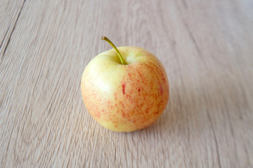 close up red apple isolated on wood background