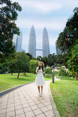 A woman tourist is sightseeing the Petronas Twin tower KLCC in Kuala Lumpur.