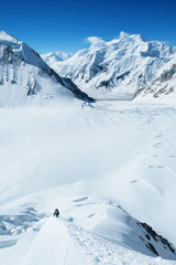 Group of climber reaches the summit of mountain peak enjoying the landscape view.