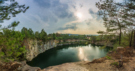 Beautiful landscape, quarry with blue and green water, wonderful view, sunset, under cloud.