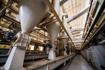 Interior of modern natural oil factory. The piping, pumps and motors