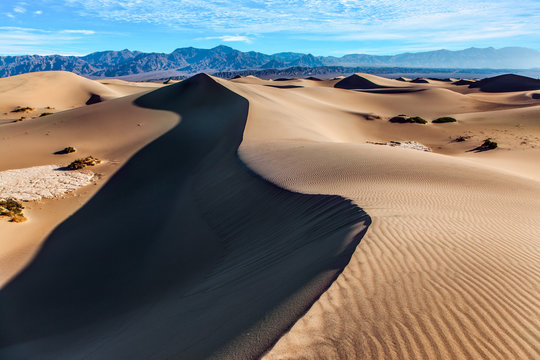 Dunes illuminated by orange sunset