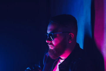 Portrait of bearded hipster man in night