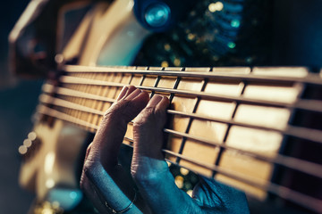 Closeup photo of bass guitar player hands - Powered by Adobe