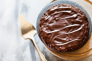 Chocolate brownie cake with ganashe topping on gray background