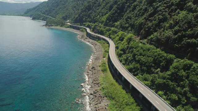 Aerial view of Patapat viaduct in the coast of Pagudpud, Ilocos Norte. Highway with bridge by coast sea near the mountains. Philippines, Luzon.