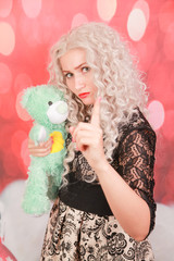 Teddy bear is a best friend for all girls. pretty curly blonde with green teddy bear toy