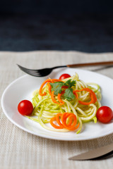Zucchini spaghetti with tomato and carrot