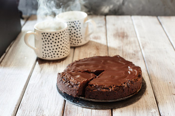 Chocolate brownie cake with ganashe topping on gray background