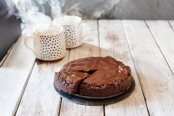 Chocolate brownie cake with ganashe topping on gray background