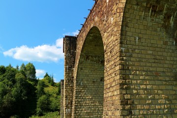  The walls of the old viaduct bridge against the sky
