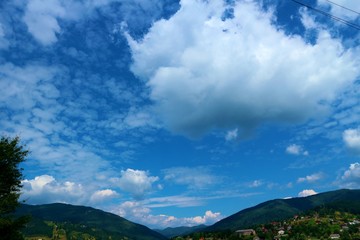 Mountains on a blue background of sky and clouds