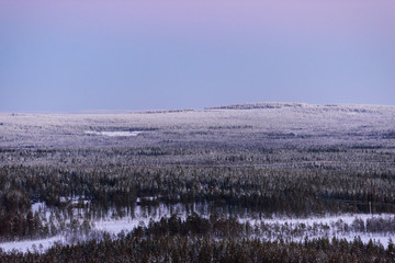 Obraz premium The landscape forest has covered with heavy snow and sunset sky from top view landscape in winter season at Lapland, Finland.