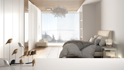 White table top or shelf with minimalistic bird ornament, birdie knick - knack over blurred contemporary luxury bedroom with double bed and big panoramic window, modern interior design