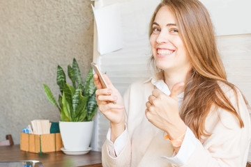 Business woman with smartphone working in open office place