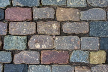 ancient stone wall of bricks of various shapes, sizes and colors. rough surface texture