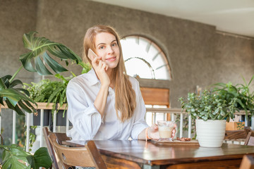 Business woman with smartphone working in open office place