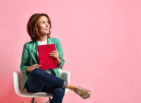 Young Woman Studying Whith Notepad In A Chair