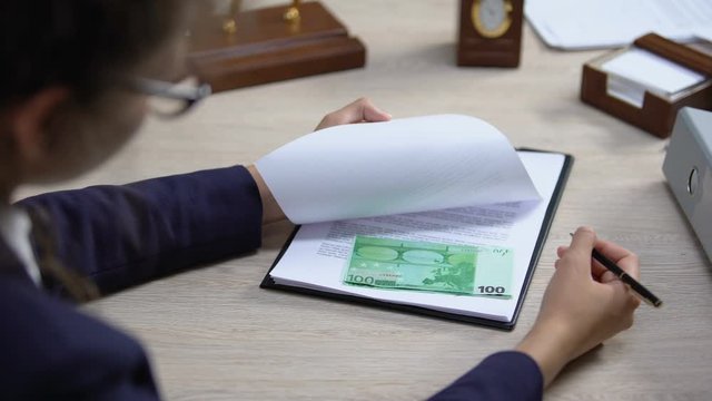 Female officer looking euro banknotes under visa application, embassy corruption