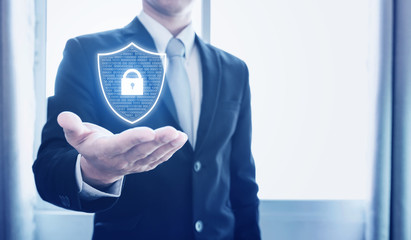 Protection business network and digital data. Businessman holding shield with lock icon