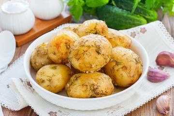 Whole baked potato with dill and garlic, horizontal