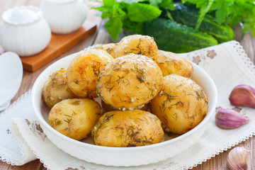 Whole baked potato with dill and garlic, horizontal