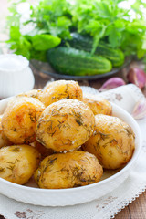 Whole baked potatoes with dill and garlic, selective focus