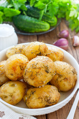 Whole baked potatoes with dill and garlic, selective focus