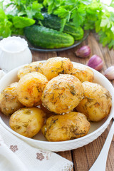 Whole baked potatoes with dill and garlic, selective focus