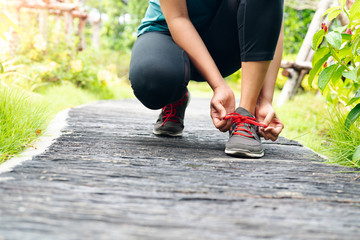 sport woman tying shoelace before running, outdoor activities