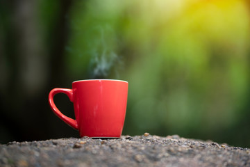 Red cup of coffee with natore background