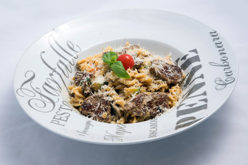 A high contrast Hero shot of a Meat & sprinkled Cheese Pasta, on a minimal white background with a 30 degree angle from zoomed in slant perspective