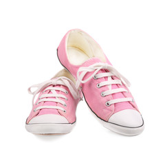 Pair of pink female sneakers isolated on white