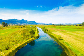 Colorful Gacka valley field and river aerial summer view, Lika region of Croatia