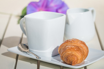 Delicious croissants with cup of coffee for breackfast on white table