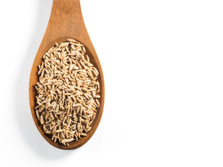 Cumin seeds (Cuminum), Jeera in wooden spoon on a white background vertically
