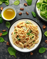Pasta with roasted walnut, ricotta white pesto sauce, parmesan cheese and spinach
