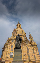 Fototapeta na wymiar Dresden, Saxony, Germany. State of reformer Martin Luther in front of the Frauenkirche which which was rebuilt after the II. World War