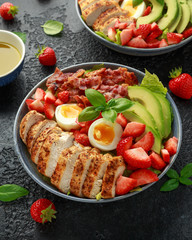 Chicken Cobb salad with strawberries, bacon, avocado and boiled eggs