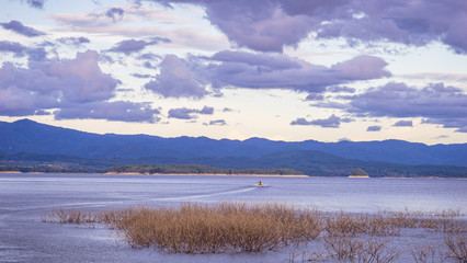 boat on a mountain lake with sunlight.Natural dam lake in forest.