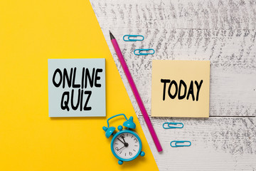 Word writing text Online Quiz. Business photo showcasing game or a mind sport that are published on the Internet Notepads marker pen colored paper sheet alarm clock wooden background