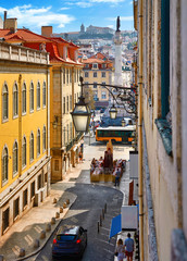 Lisbon, Portugal. Day streets with road under street lamps on walls. Old downtown city centre. View...