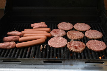 Hamburgers, hot dogs and sausages on the grill