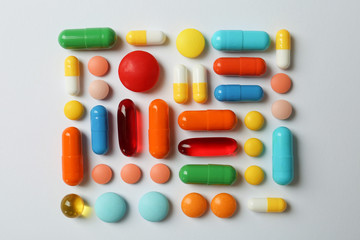 Many different pills on white background, top view