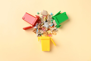 Trash bins and different garbage on color background, top view. Waste recycling concept