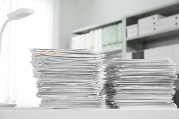 Stacks of documents on table in office