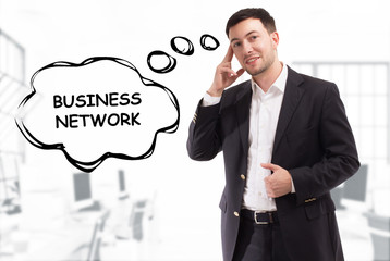 Business, technology, internet and network concept. The young businessman comes up with the keyword: Business network