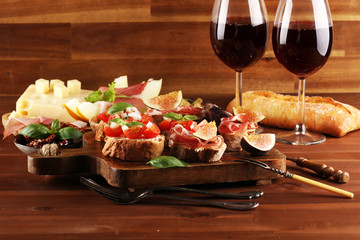 Tasty savory tomato Italian appetizers and bread with coppa and prosciutto di parma
